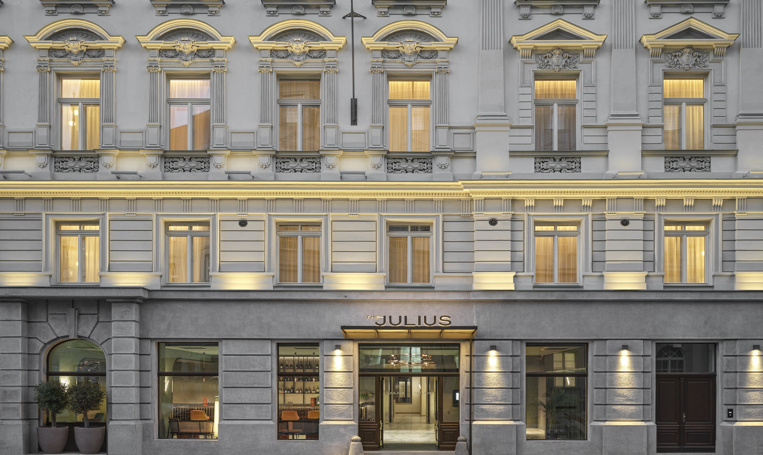 The Julius Prague facade at dusk with lit windows